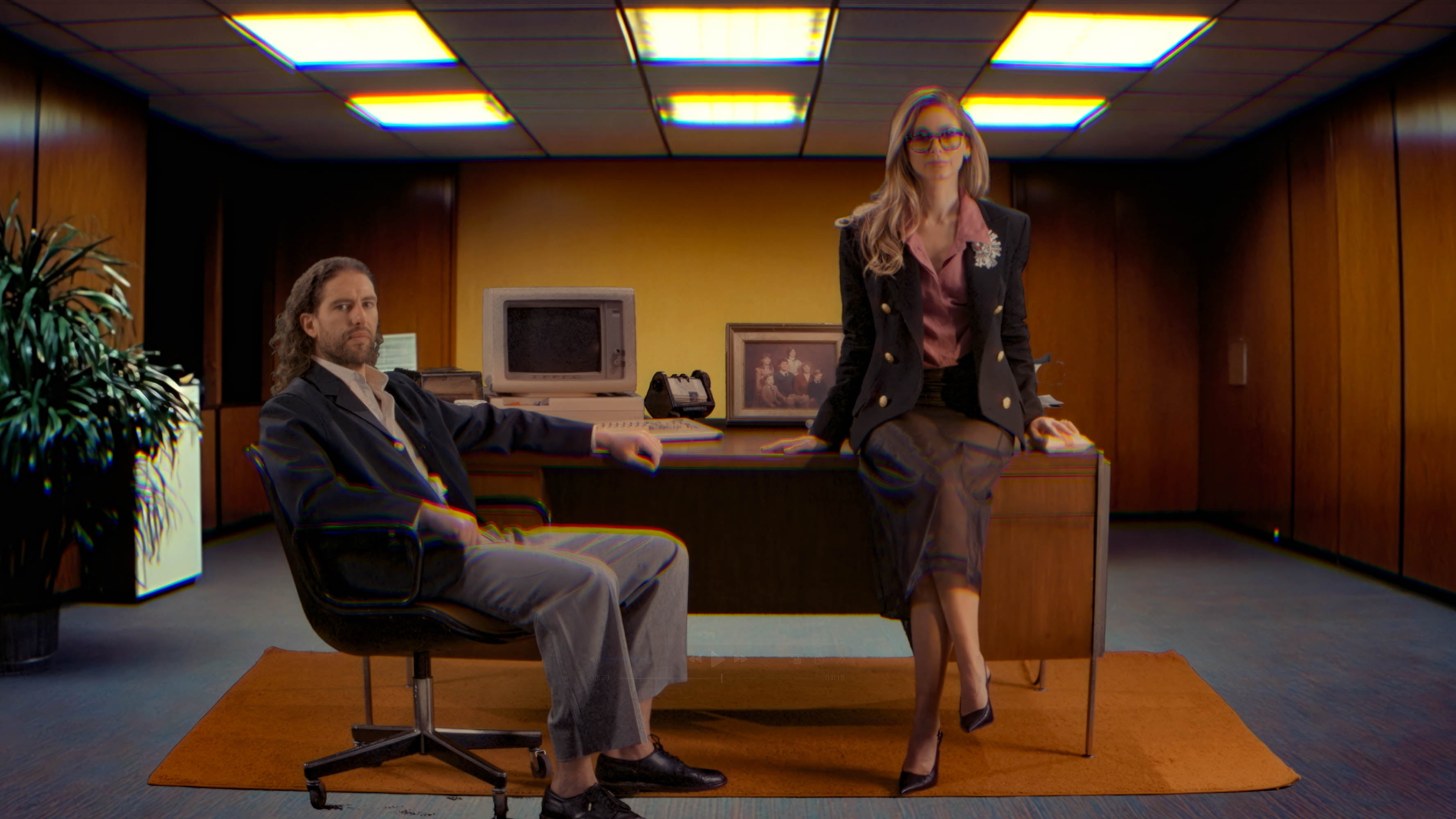 Two people in a office setting with a computer and desk. Joshua Katz and Carli Roth founders of Norms Hemorrhoid Treatment company